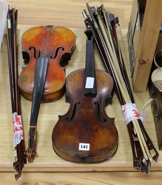 Two Saxon violins and approx. 25 assorted bows